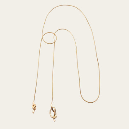 Time4Me 100cm long gold stainless steel necklace featuring an elegant asymmetrical knot design