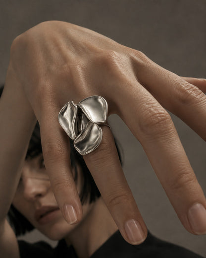Time4Me adjustable silver-tone stainless steel ring featuring a sculptural three-petal floral design on a hand