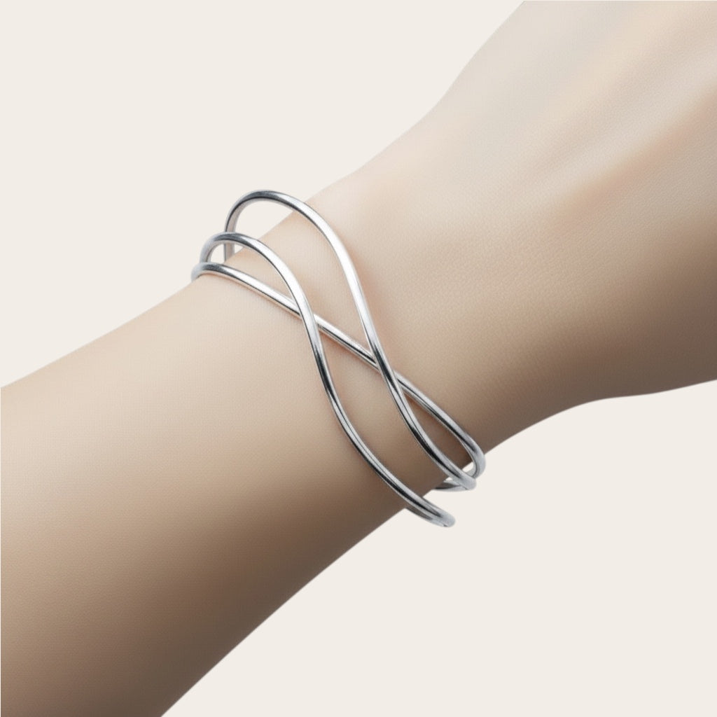 Time4Me silver open cuff bracelet with elegant crisscross lines worn on a wrist, made of durable stainless steel.