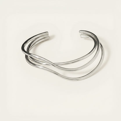 Time4Me silver open cuff bracelet featuring a modern crisscross line design made from durable stainless steel.