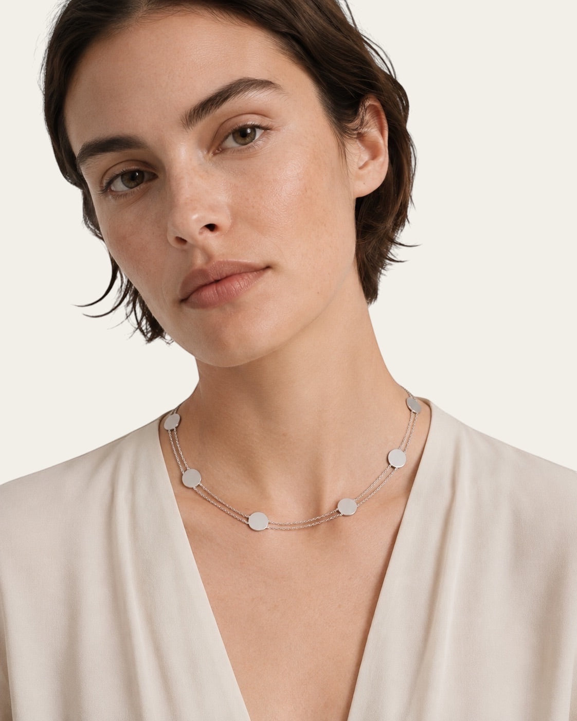 Time4Me silver double chain choker with small disc pendants worn by a woman in a cream blouse