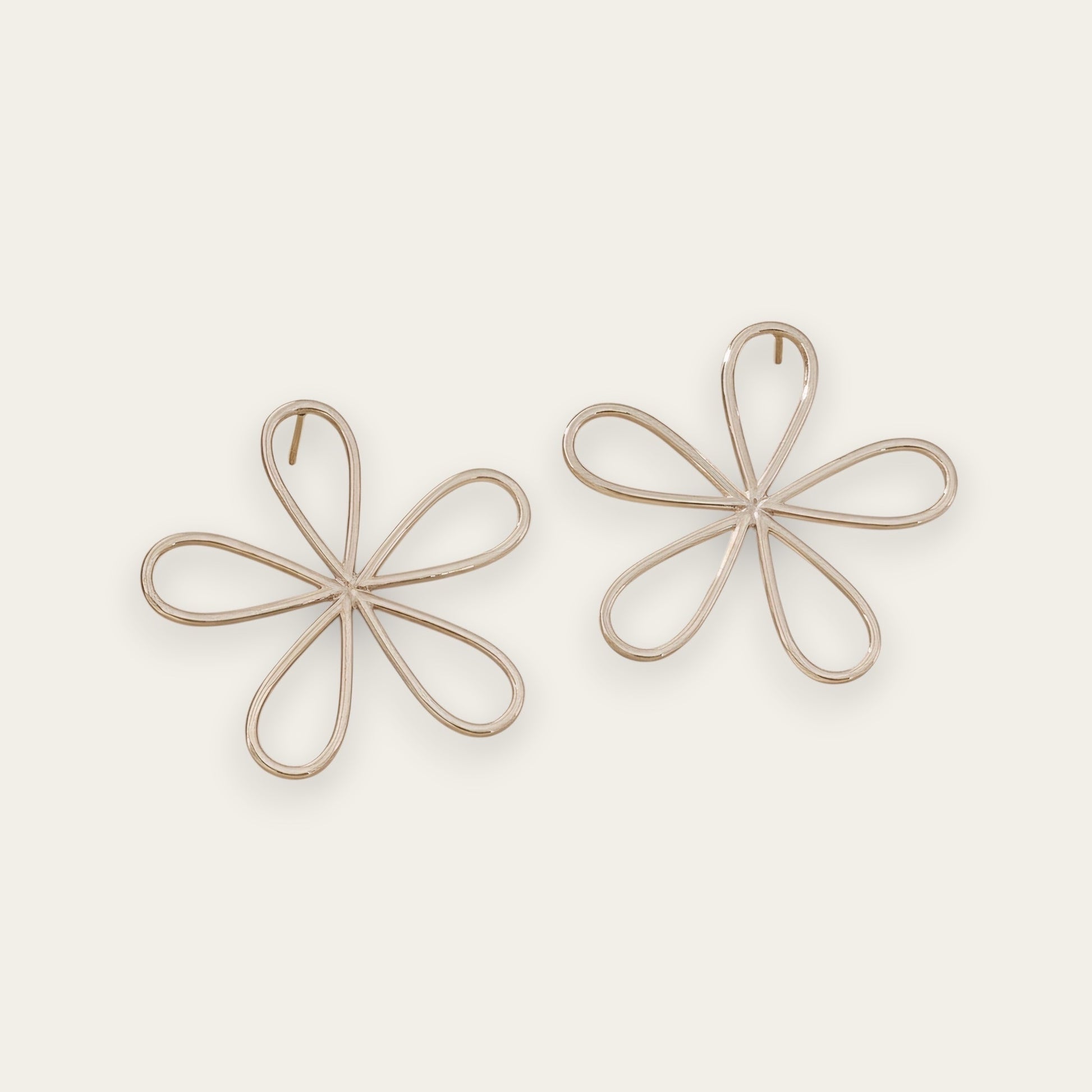 Time4Me silver-tone stainless steel stud earrings featuring a minimalist stylized flower design