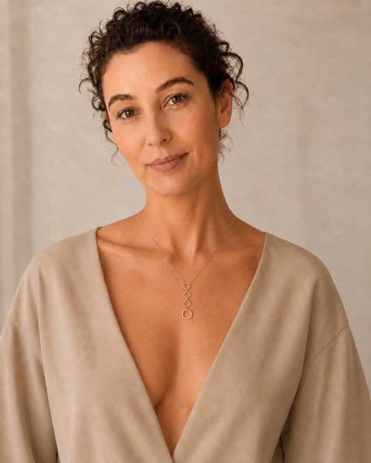Time4Me silver-toned stainless steel necklace featuring four vertically aligned circles worn by a woman