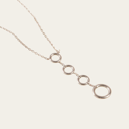Time4Me silver-tone stainless steel necklace featuring four vertically aligned circular pendants on a delicate chain.