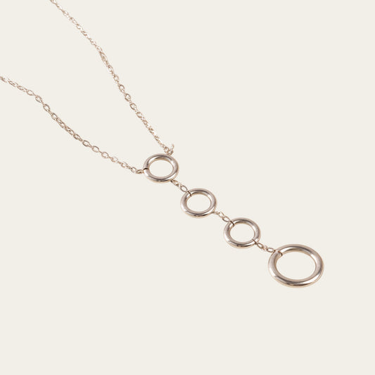 Time4Me silver-tone stainless steel necklace featuring four vertically aligned circular pendants on a delicate chain.