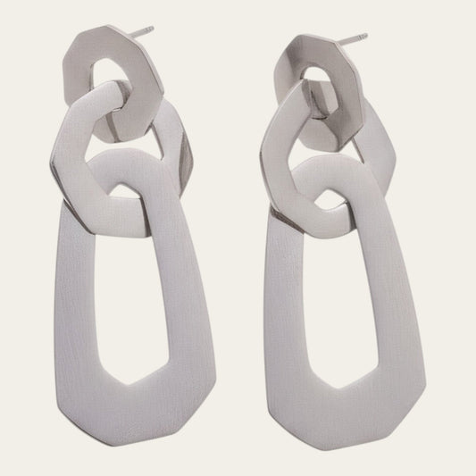Time4Me silver-toned long earrings featuring three interconnected geometric shapes made of stainless steel.