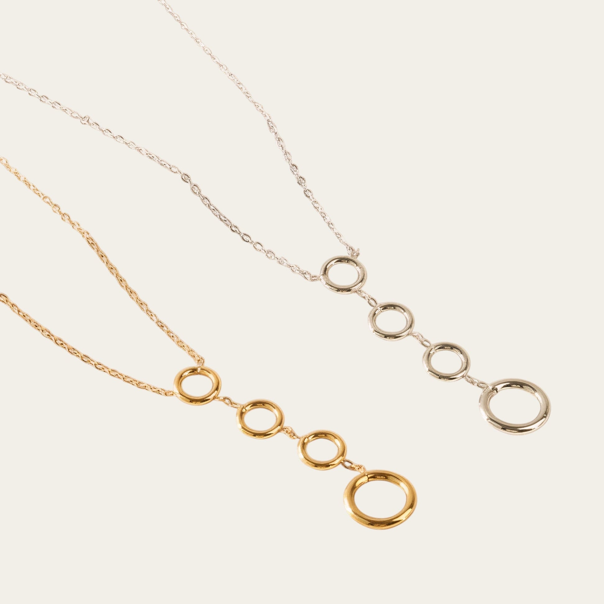 Time4Me stainless steel necklaces featuring four vertical circles in silver and gold tones on delicate chains.
