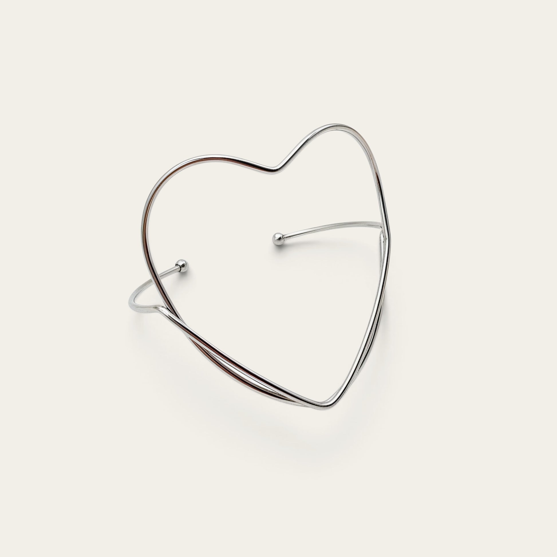 Time4Me silver-tone stainless steel open cuff bracelet featuring a minimalist heart-shaped design.