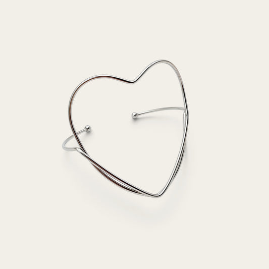 Time4Me silver-tone stainless steel open cuff bracelet featuring a minimalist heart-shaped design.