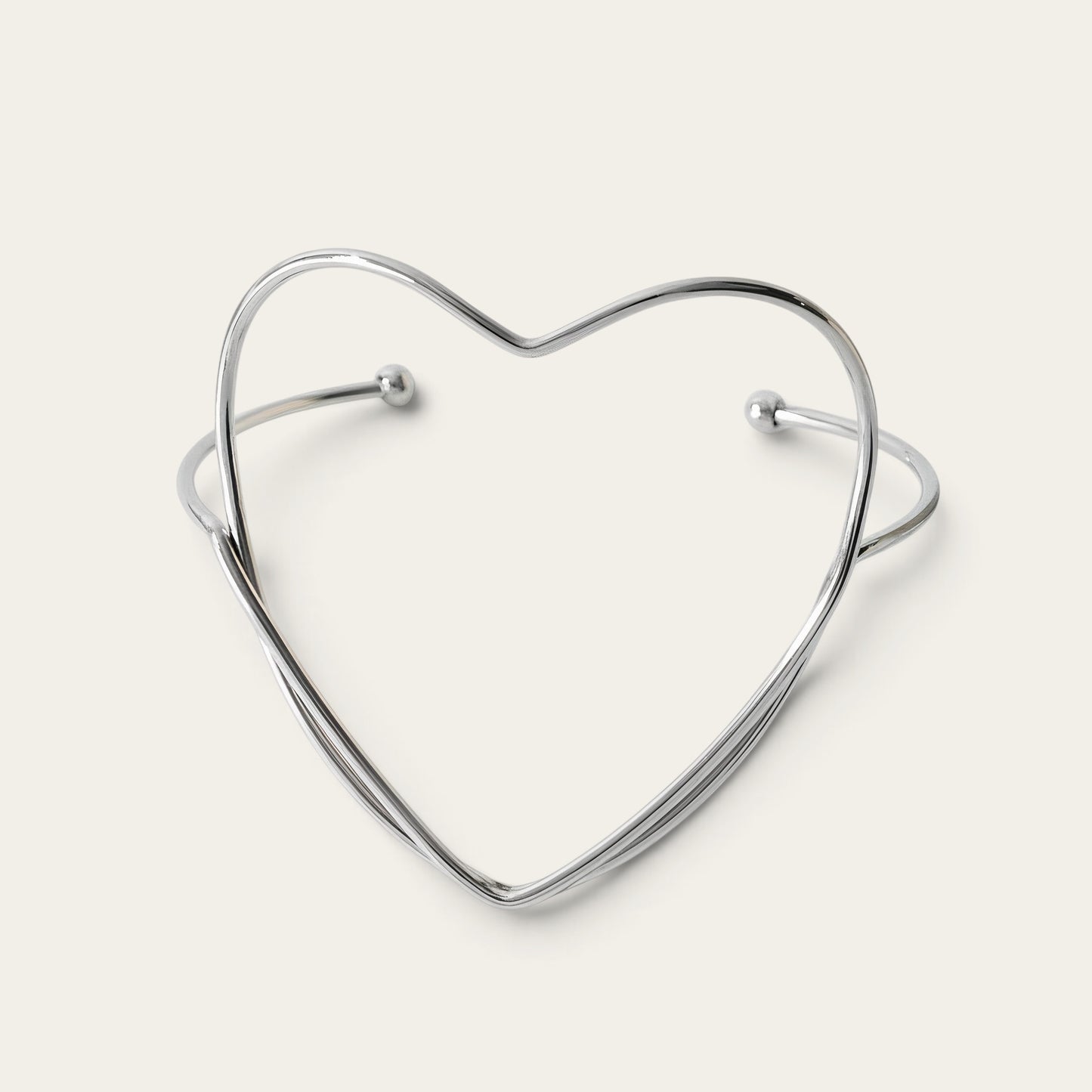 Time4Me silver-tone stainless steel open cuff bracelet featuring a minimalist heart-shaped design