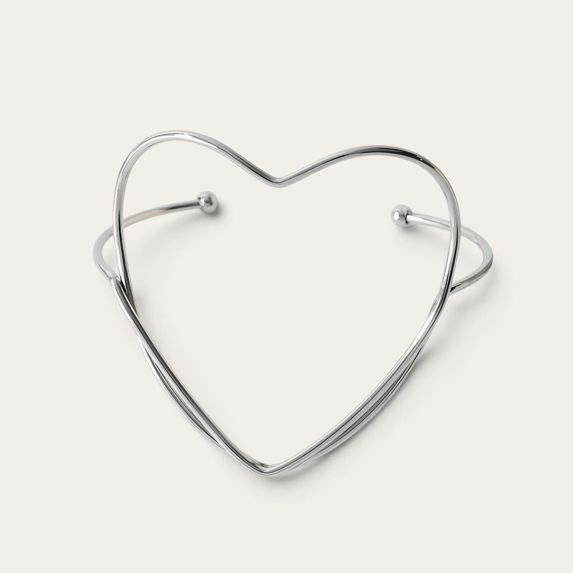 Time4Me silver-tone stainless steel open cuff bracelet featuring a minimalist heart-shaped design