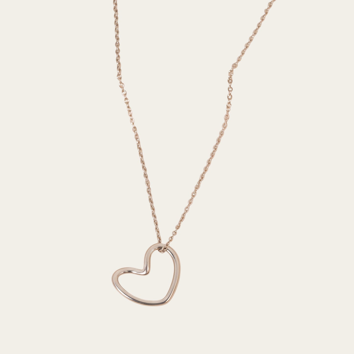 Time4Me silver-toned stainless steel necklace featuring a minimalist stylized heart pendant on a delicate chain.