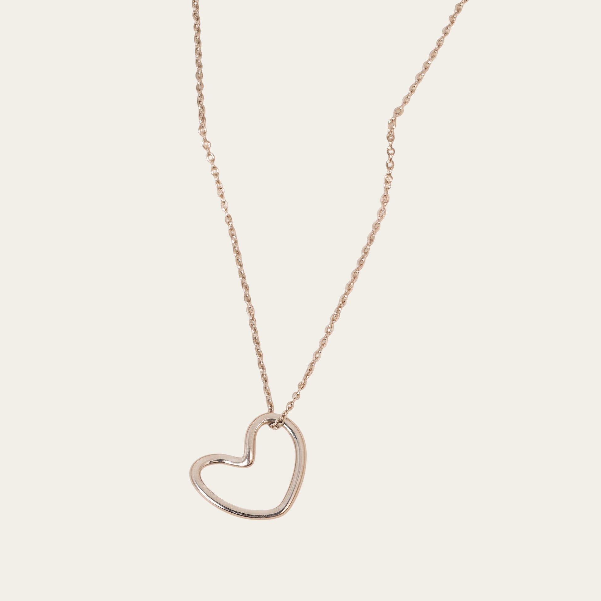 Time4Me silver-toned stainless steel necklace featuring a minimalist stylized heart pendant on a delicate chain.