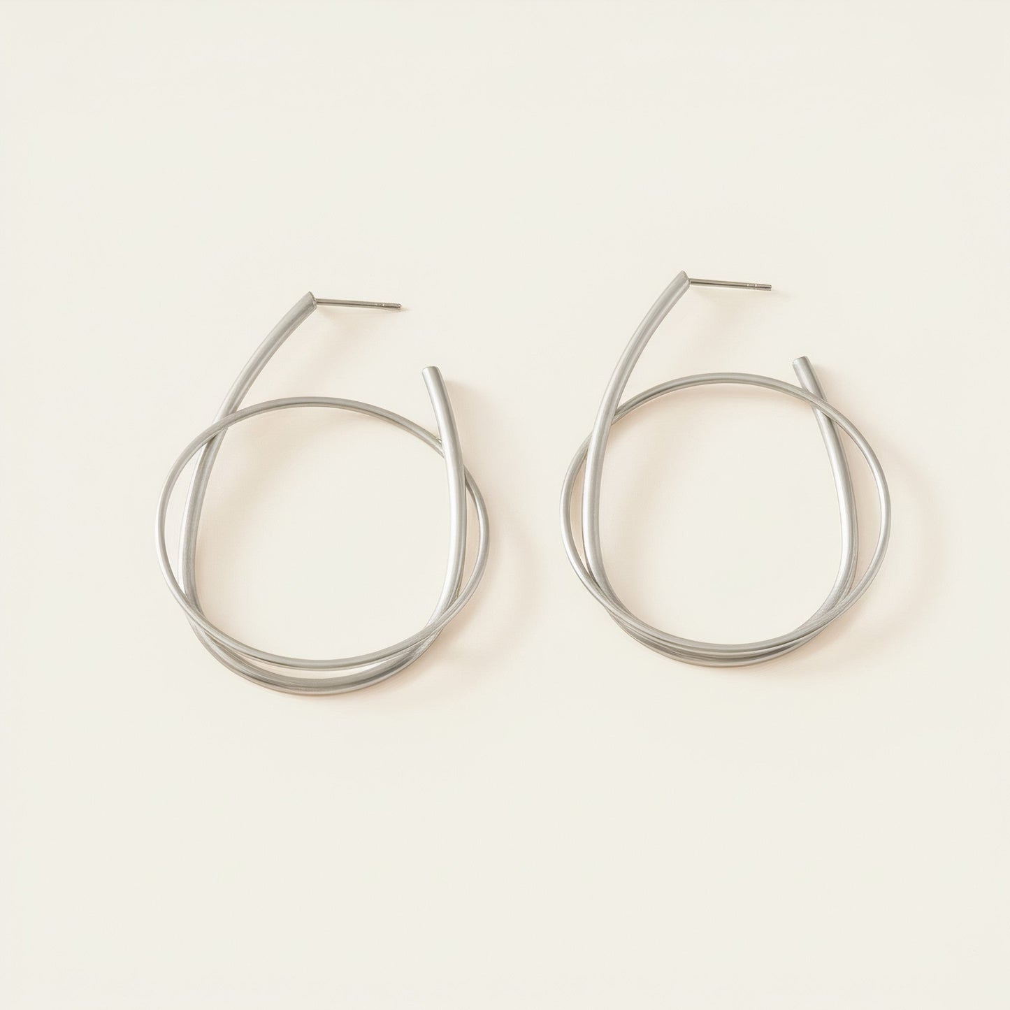 Time4Me silver hoop earrings featuring a modern intertwined ring design made from durable stainless steel