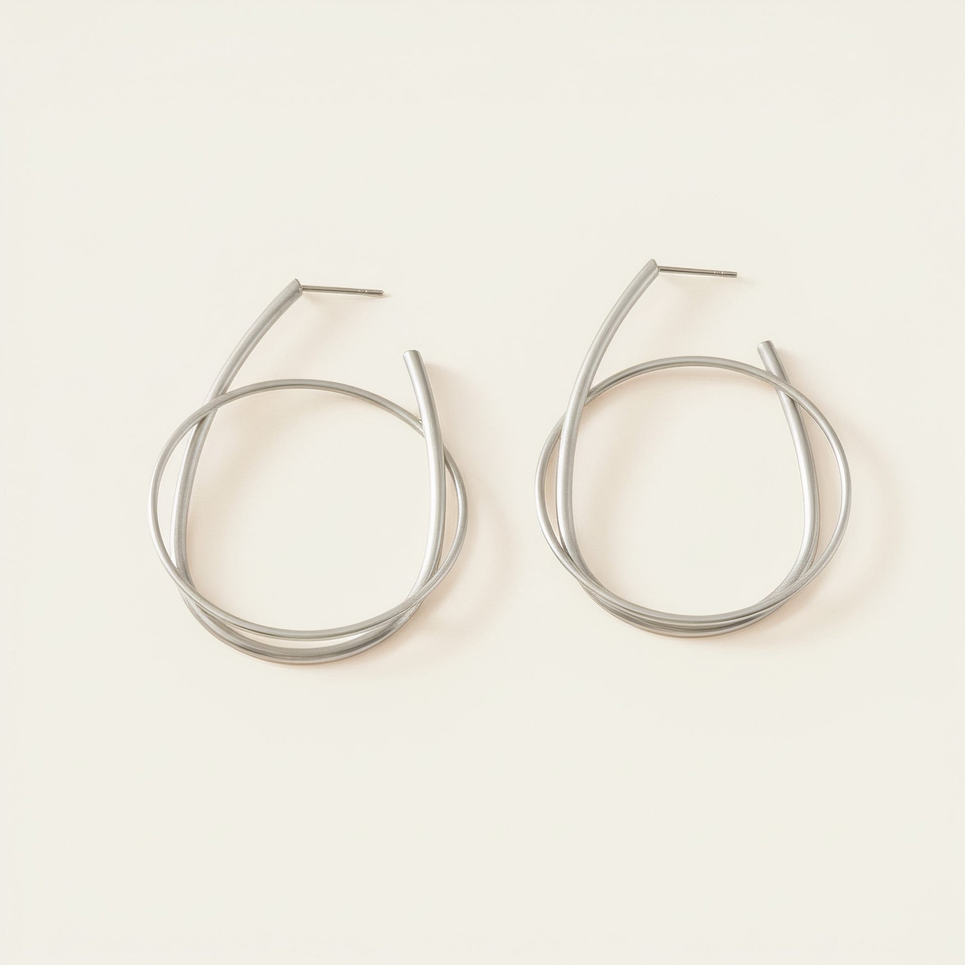 Time4Me silver hoop earrings featuring a modern intertwined ring design made from durable stainless steel
