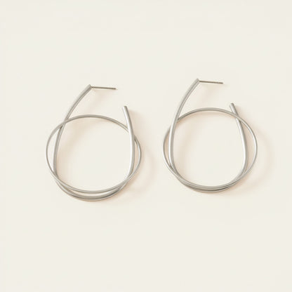 Time4Me silver hoop earrings featuring a modern intertwined ring design made from durable stainless steel