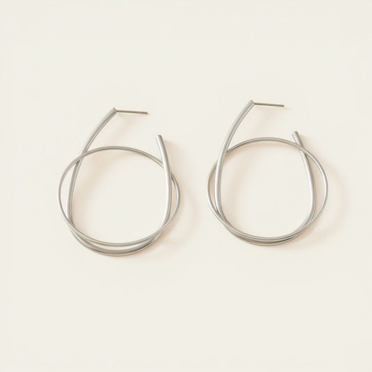 Time4Me silver hoop earrings featuring a modern intertwined ring design made from durable stainless steel