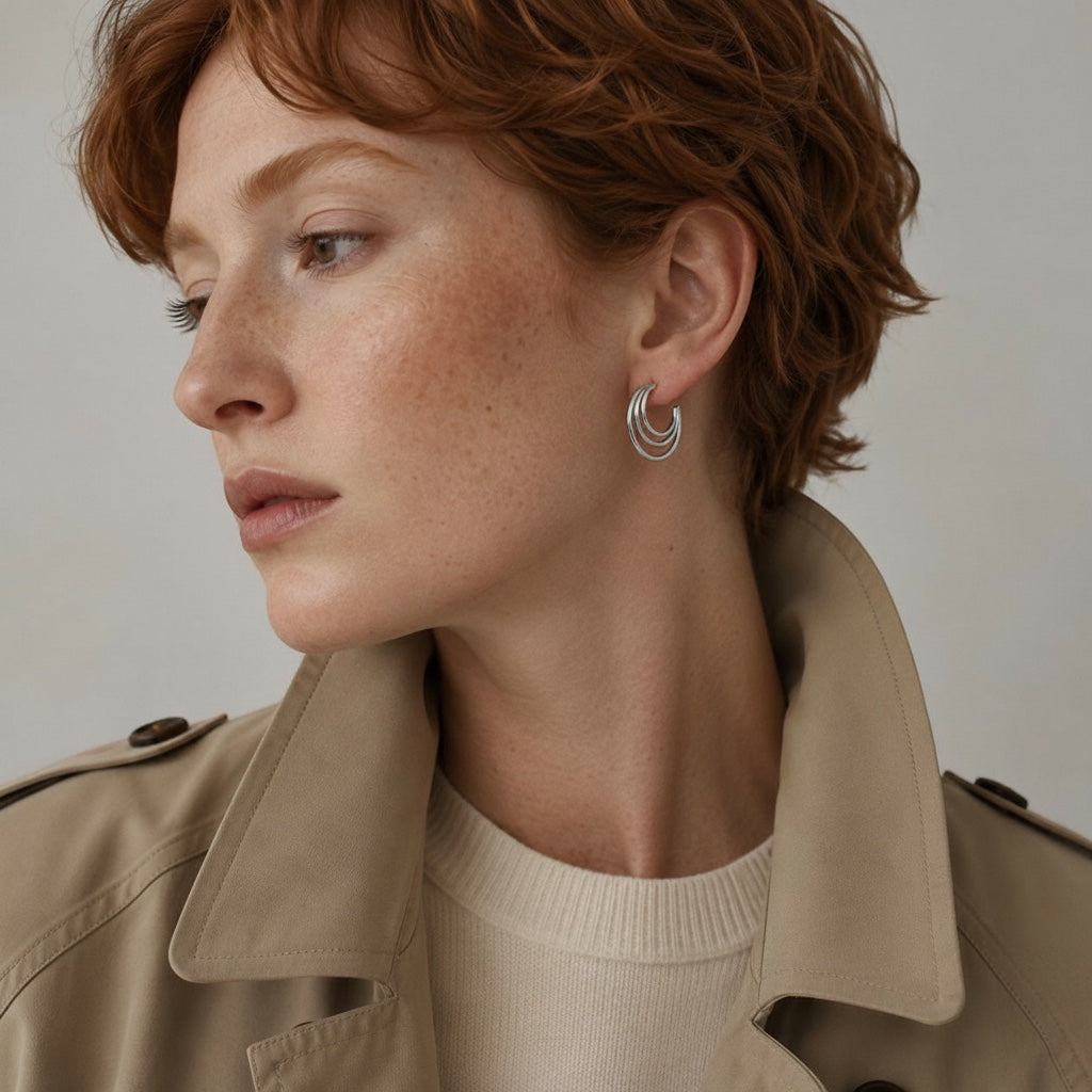 Time4Me silver-tone layered thin hoop earrings worn by a woman with red hair in a beige trench coat