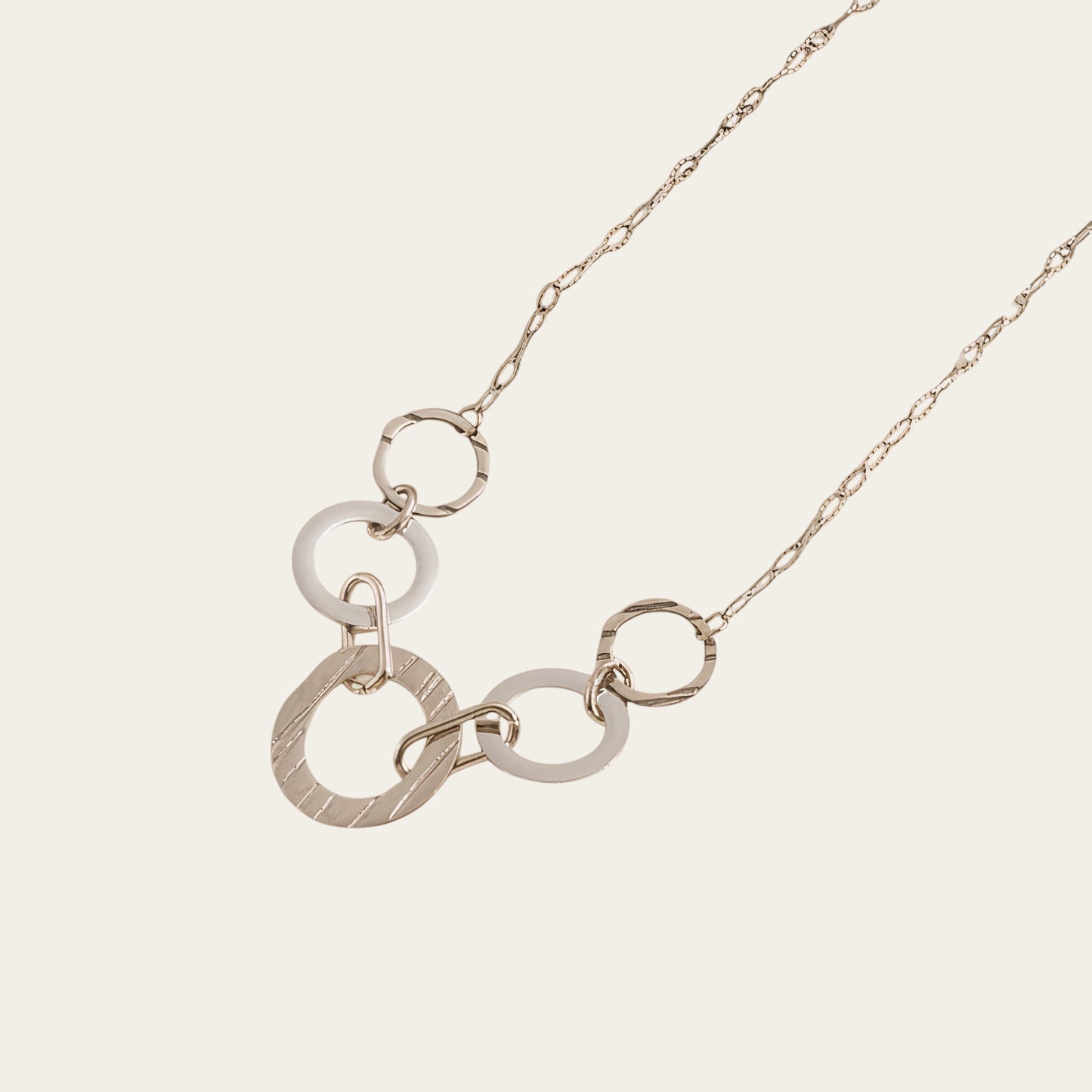 Time4Me silver-tone necklace featuring multiple interlocking smooth and brushed rings on a delicate chain