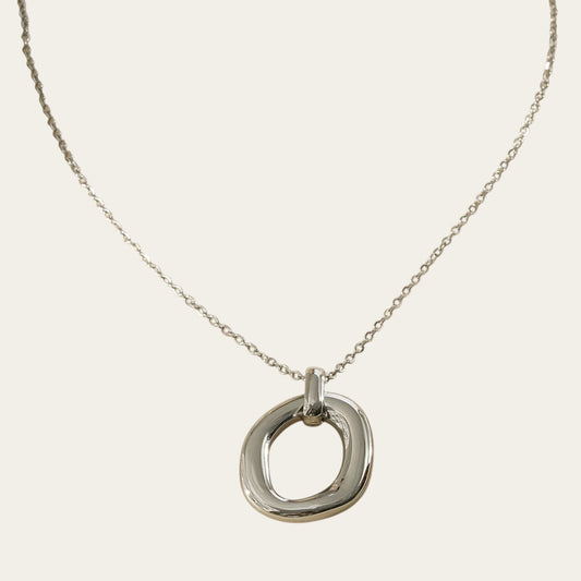 Time4Me silver-toned stainless steel necklace featuring a polished oval pendant with a relief design on a fine chain.