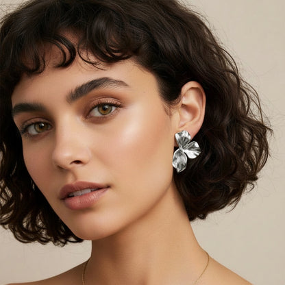 Time4Me silver petal-shaped stainless steel earrings worn by a woman with short dark hair