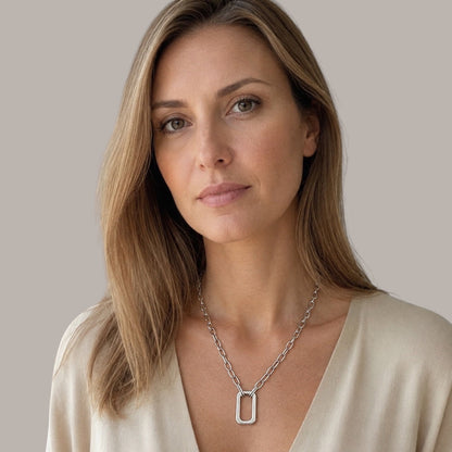 Time4Me silver chain necklace with a large rectangular pendant worn by a woman in a beige top