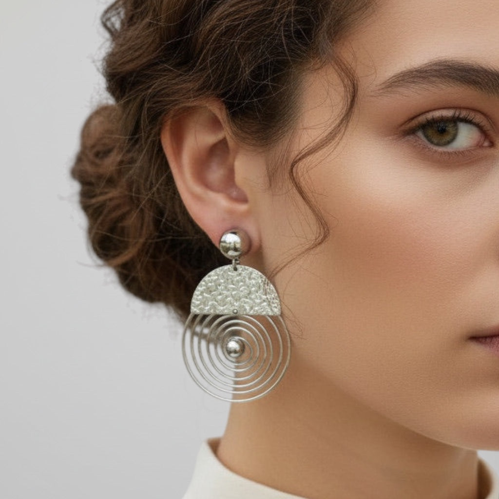 Time4Me silver spiral earrings made of stainless steel with a textured semi-circle top worn by a woman