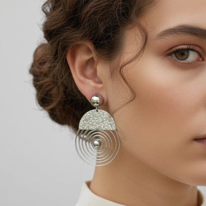 Time4Me silver spiral earrings made of stainless steel with a textured semi-circle top worn by a woman