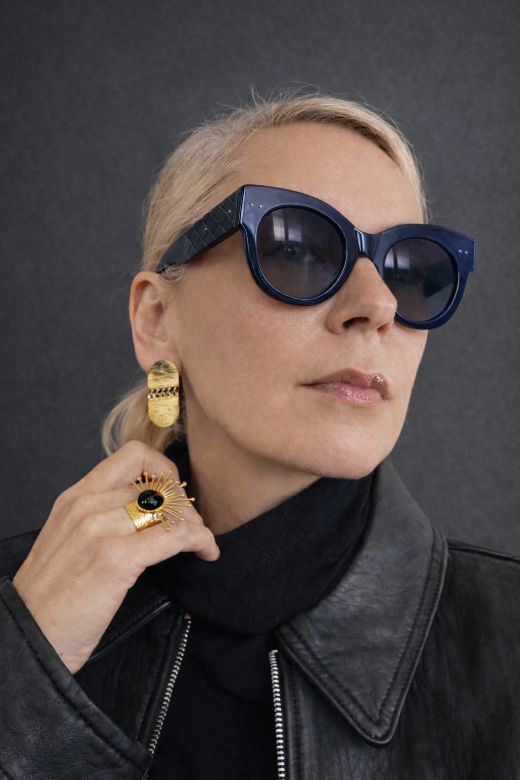 Time4Me textured gold-tone earrings worn by a woman with dark sunglasses and a black leather jacket