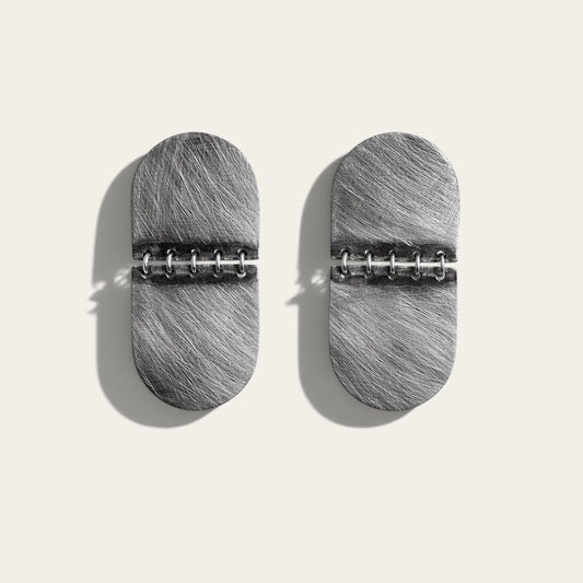 Time4Me silver-toned textured stainless steel oval earrings with a hinged design on a neutral background