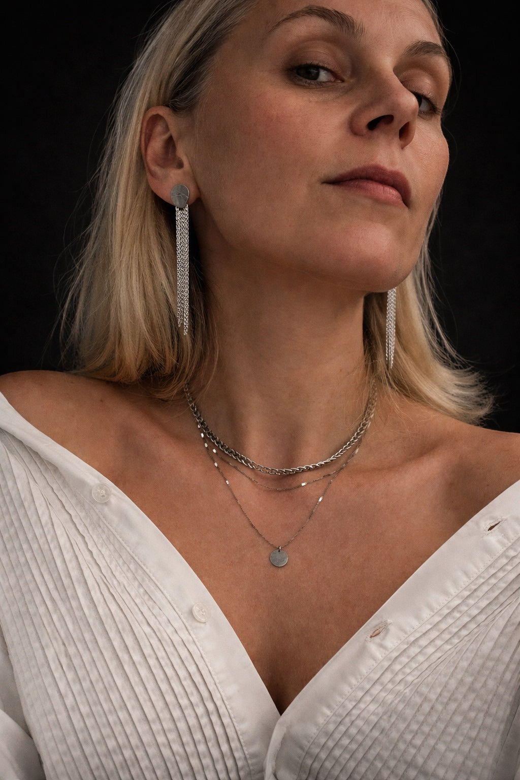 Time4Me silver triple chain necklace with round pendant worn by a woman with matching tassel earrings