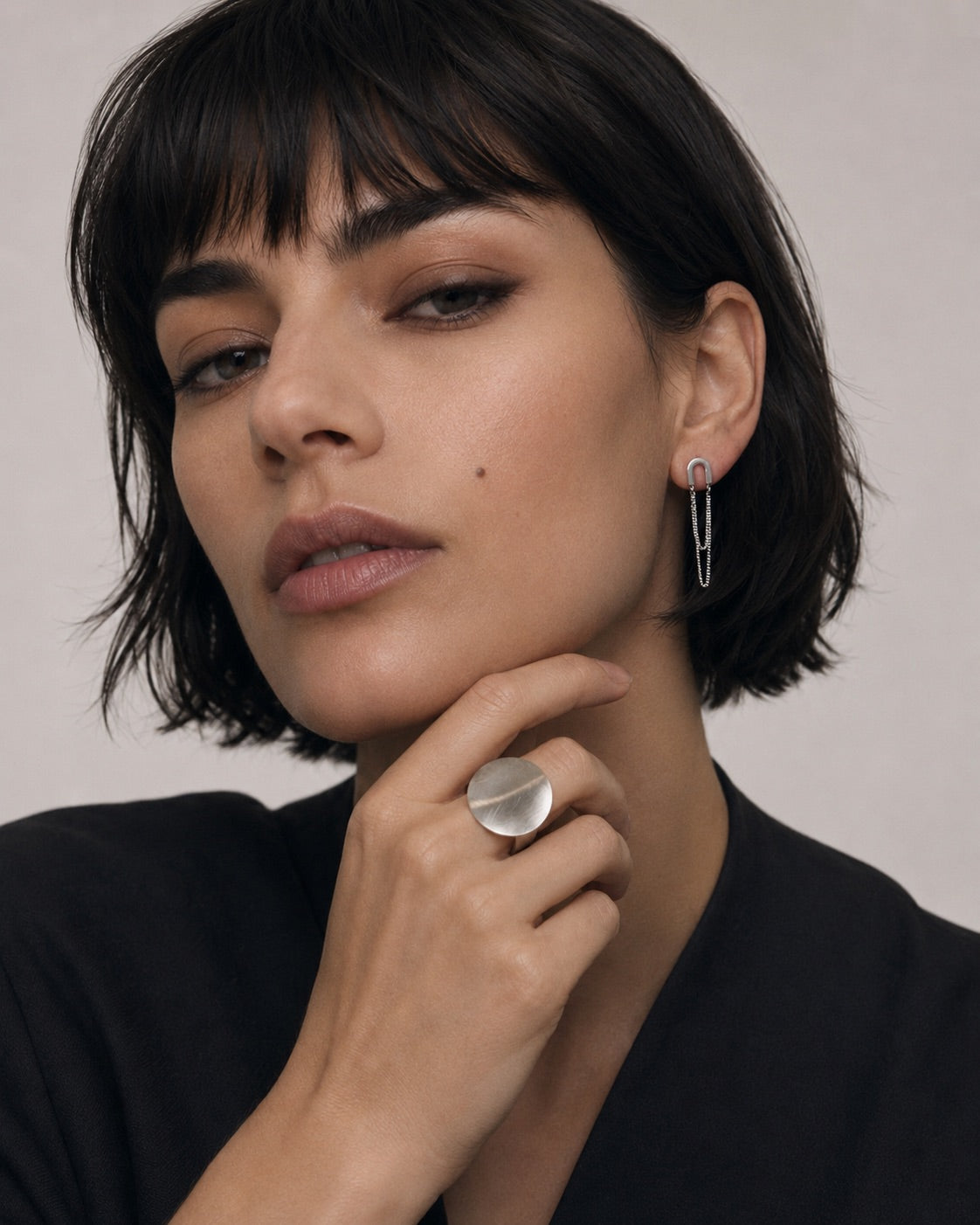 Time4Me silver U-shaped earrings with double chains worn by a woman with a matching silver ring