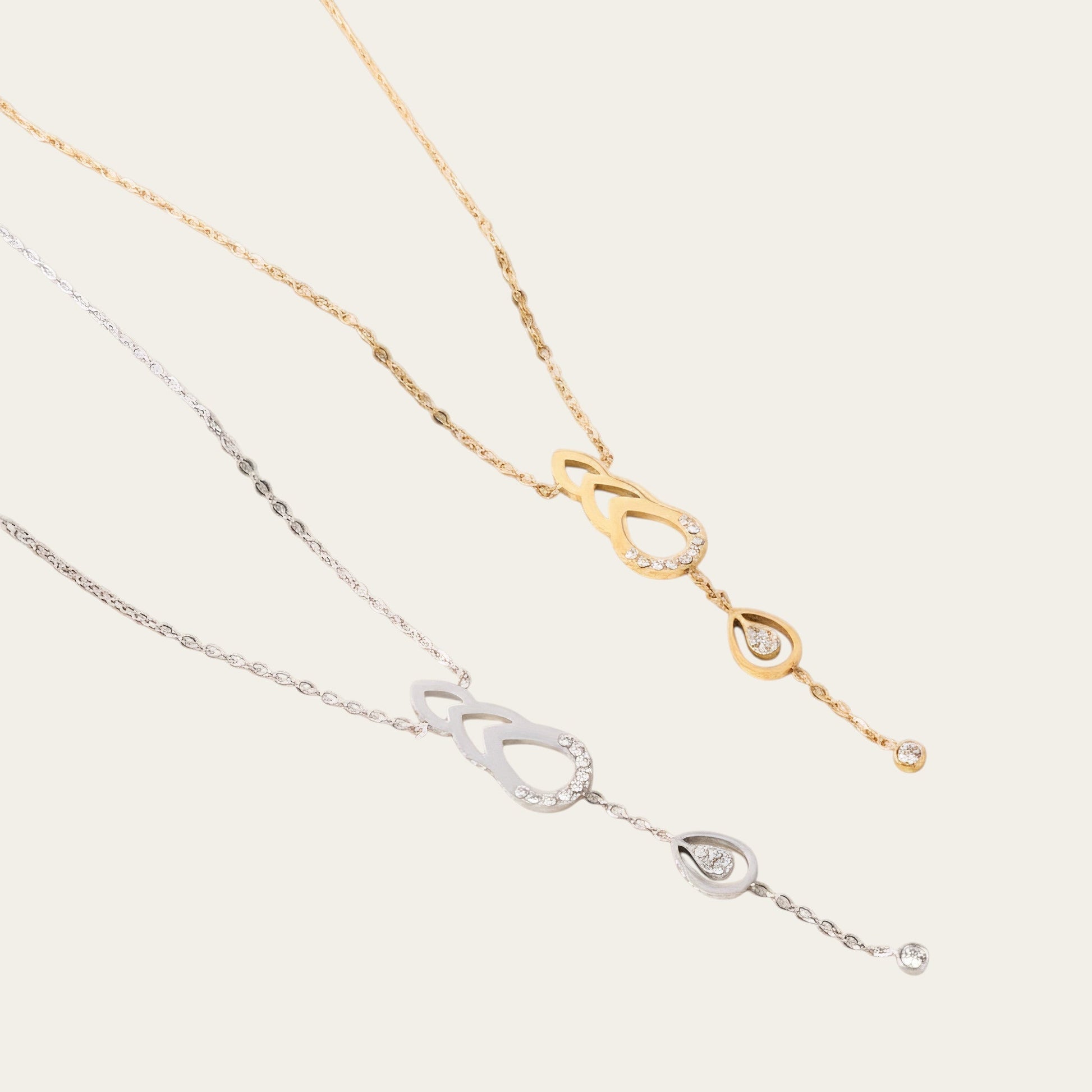 Time4Me gold and silver stainless steel necklaces featuring teardrop pendants with sparkling rhinestone accents