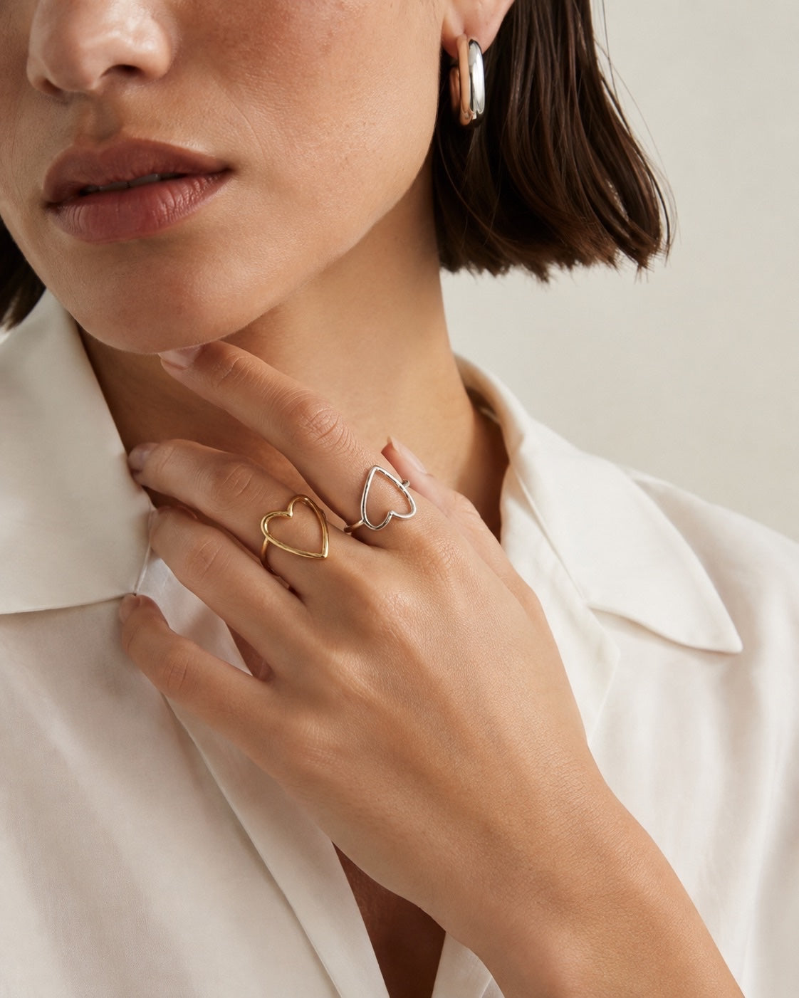 Time4Me thin gold and silver heart-shaped adjustable stainless steel rings worn on a woman's hand