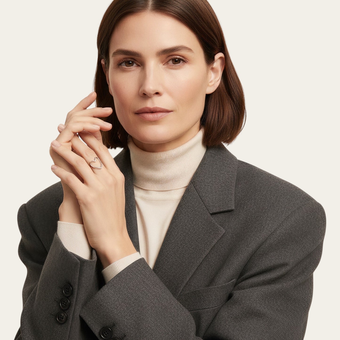 Time4Me adjustable silver-tone stainless steel heart ring worn by a woman in a grey blazer and cream turtleneck