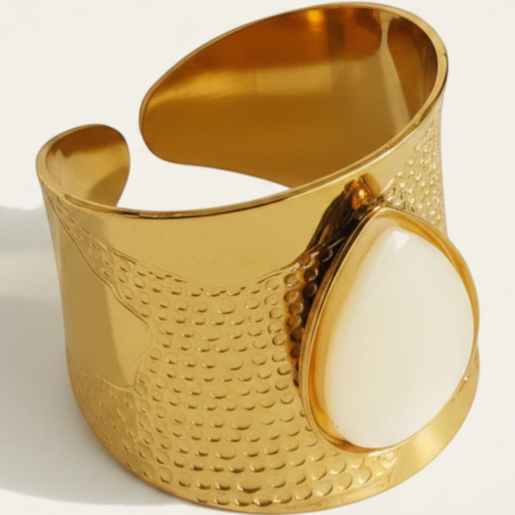 Time4Me wide gold-tone stainless steel cuff ring featuring a teardrop-shaped white stone and textured detailing.