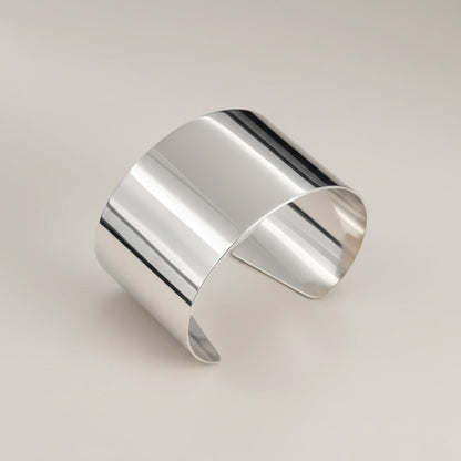Time4Me wide silver-tone open cuff bracelet made of polished stainless steel with a minimalist design.