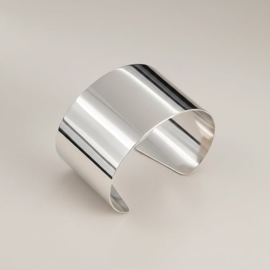 Time4Me wide silver-tone open cuff bracelet made of polished stainless steel with a minimalist design.