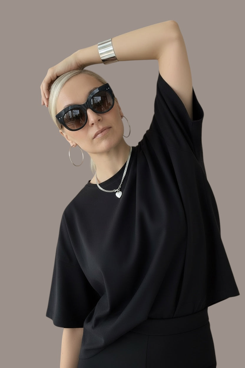 Time4Me wide silver open cuff bracelet worn by a woman in a black outfit and sunglasses